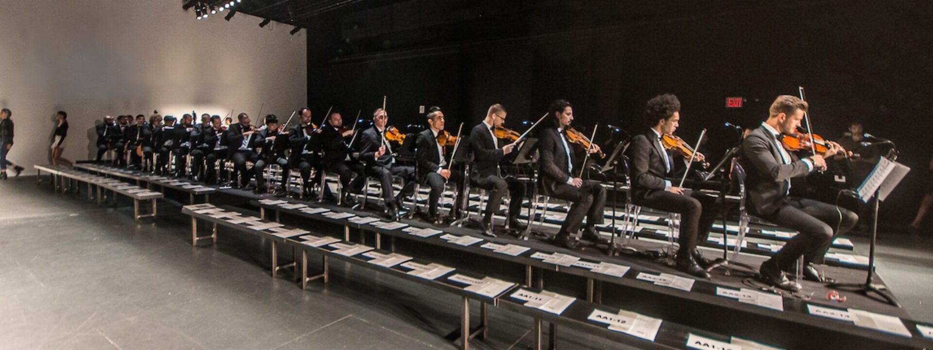 NY Fashion week. Runway show with male violinists